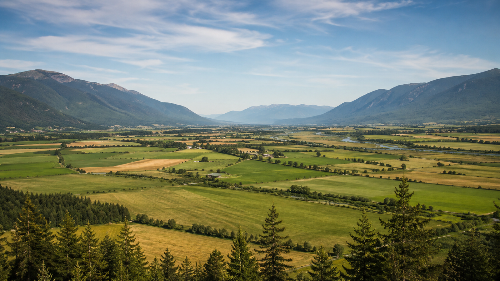 Creston Valley farmland and mountains with the Kootenay River, hero landscape for Canyon Runner Hotshot's Creston hub
