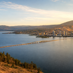 Elevated view of Okanagan Lake and the city of Kelowna, BC at golden hour, surrounded by hills