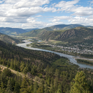 Aerial view of the Similkameen and Tulameen river valley at Princeton, BC, with forested hills and a hazy sky