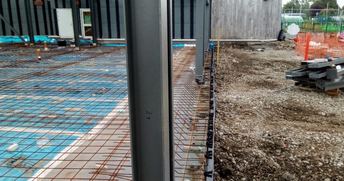 Construction site foundation with steel reinforcement, ready for a concrete pour